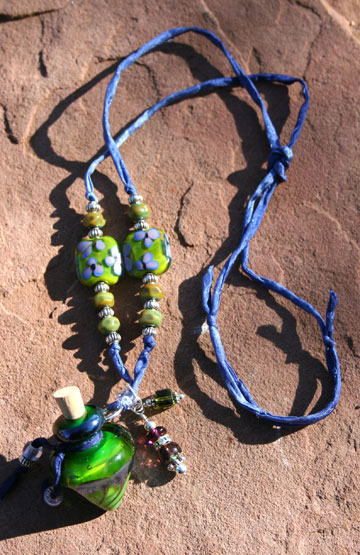 aromatherapy jewelry with violet flowers on glass beads