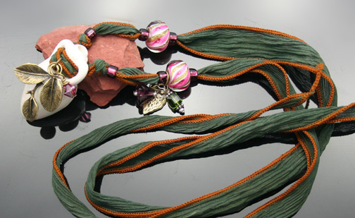 aromatherapy amphora necklace with brass charms, crystal beads and silk ribbon