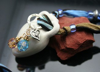 aromatherapy amphora pendant with charms and silk ribbon