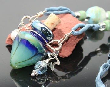 lampwork glass aromatherapy jewelry with silver charms, pearls, beads, and silk