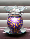 Picture of our celestial, electric aromatherapy diffuser featuring shooting golden starts on a deep blue background